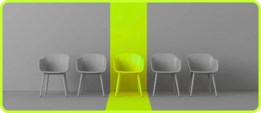 One neon chair standing out among grey chairs — symbolizing differentiation in branding challenges