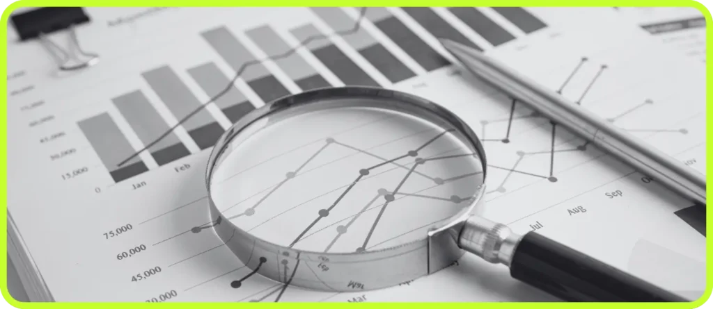 Magnifying glass over data charts symbolizing analysis and performance tracking